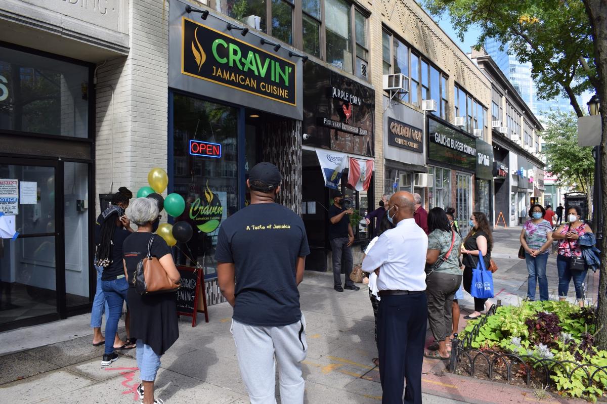 Cravin Jamaican Cuisine White Plains grand opening with crowd outside the storefront