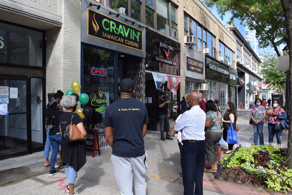 Cravin Jamaican Cuisine White Plains grand opening with crowd outside the storefront